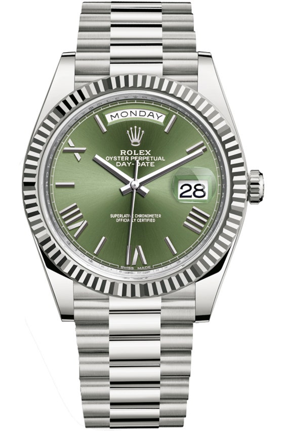 A silver watch with a green face