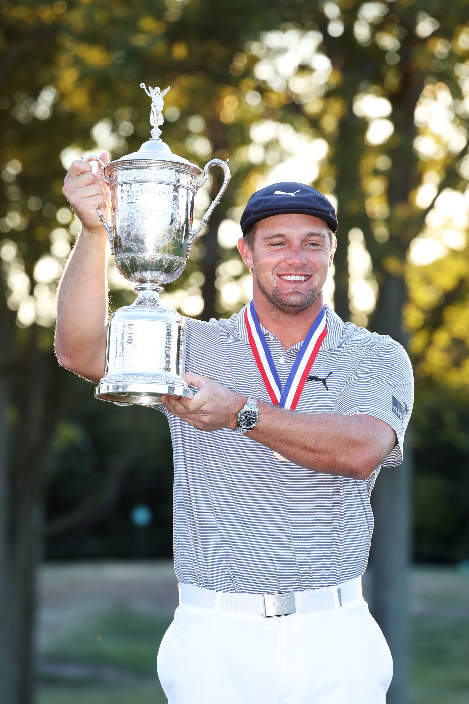 Bryson DeChambeau holding the PGA Tour Open trophy