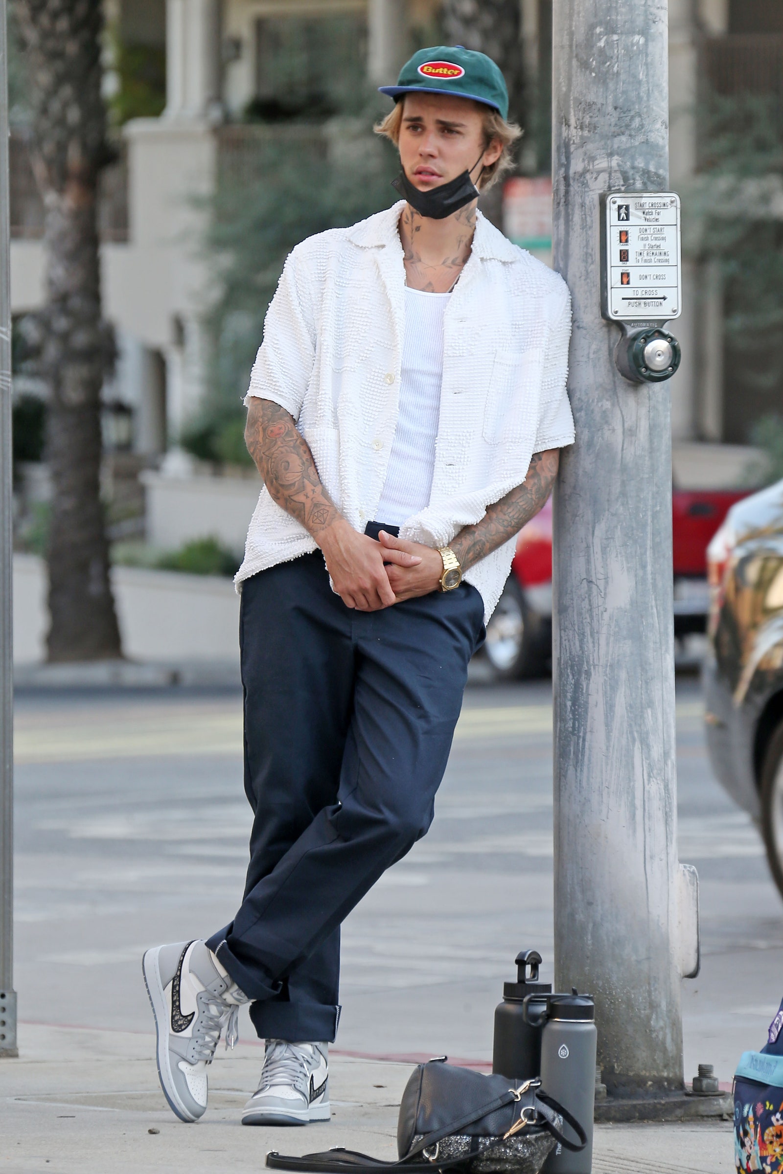 Justin Bieber leaning against a light post