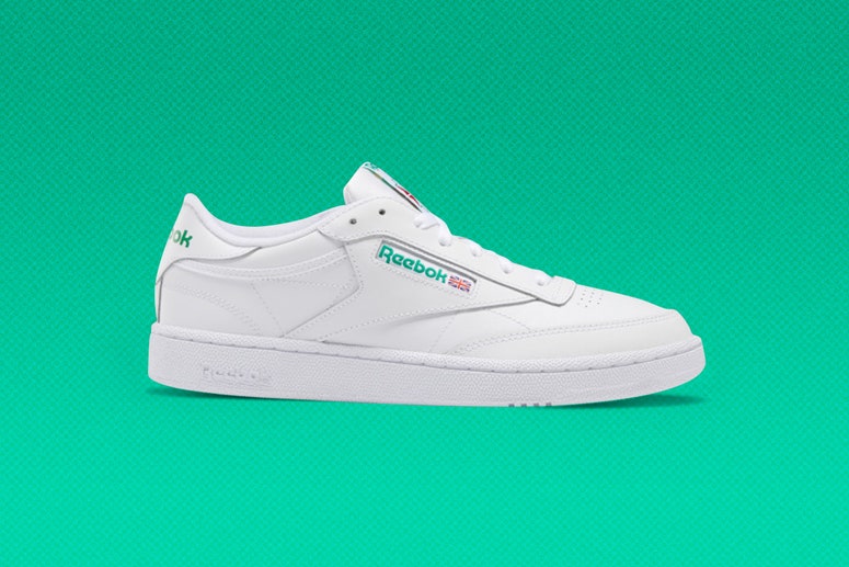 White Reebok CLUB C 85 sneaker on a green background