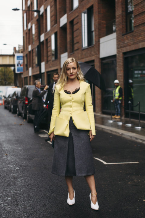 Woman in yellow blazer and grey pants