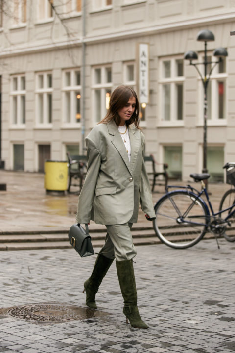 grey suit pants tucked into boots