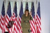 Image may contain: Melania Trump, Flag, Symbol, Human, Person, Military, Military Uniform, Army, Armored, and Soldier