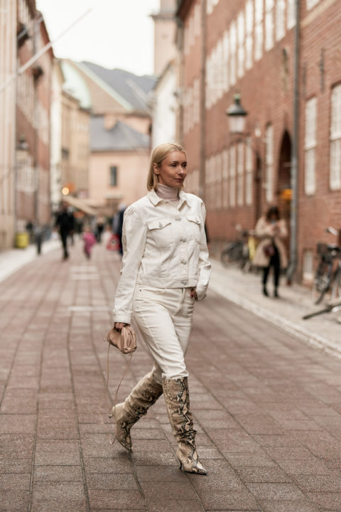 white denim pants tucked into boots