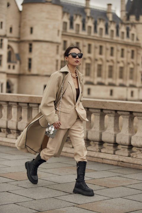 beige suit pants tucked into boots