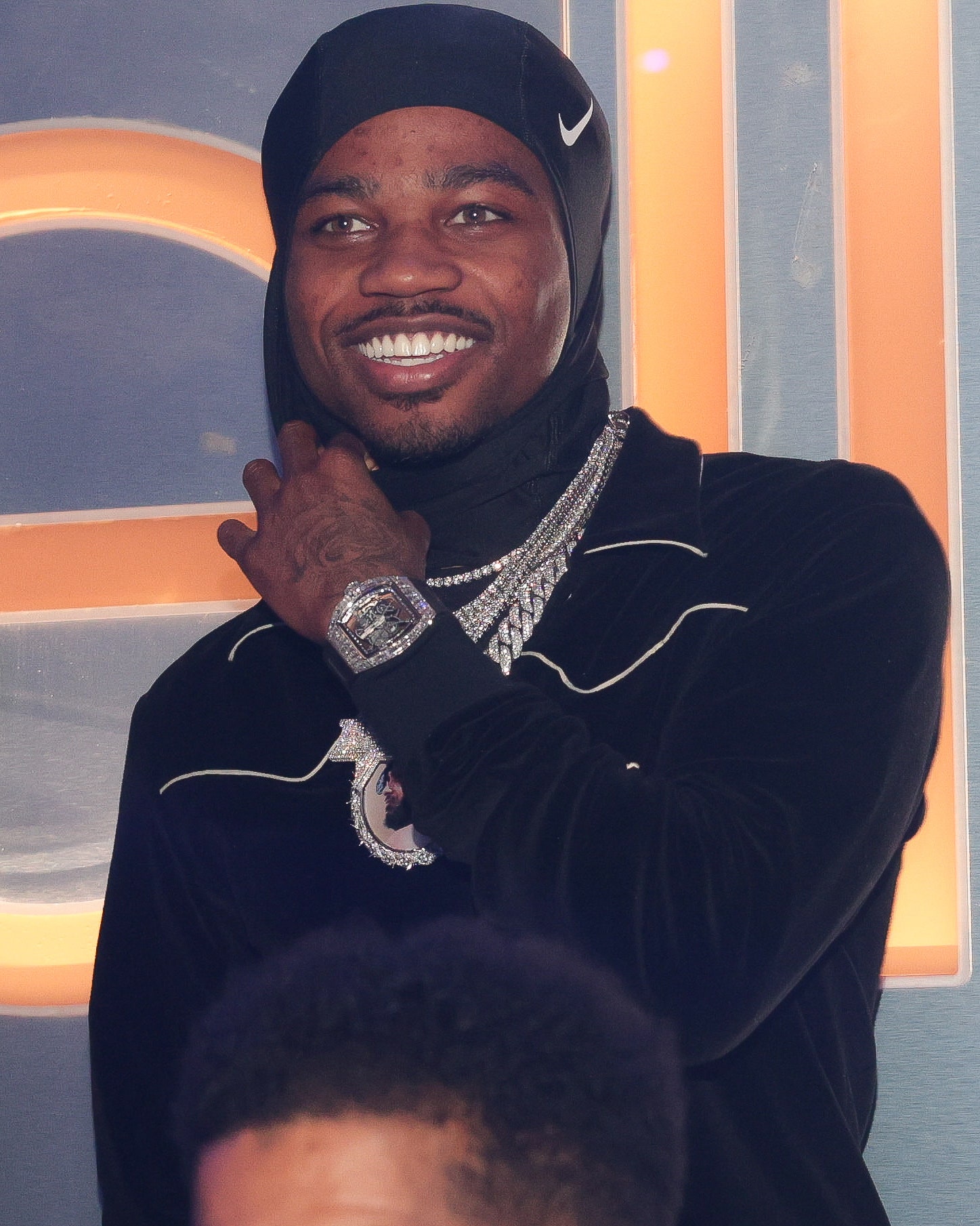 Roddy Rich smiling and wearing a nike balaclava