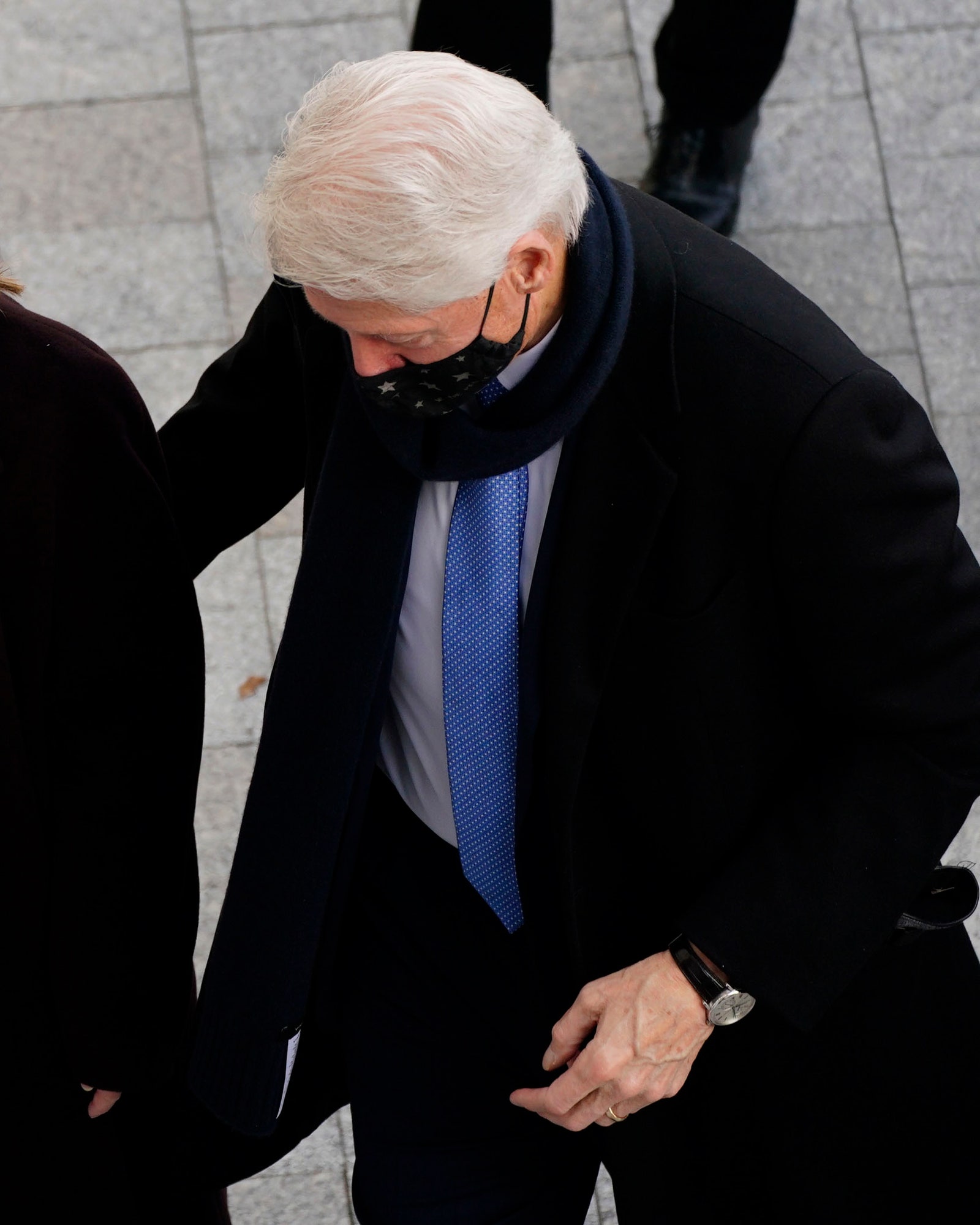 Bill Clinton walking up some steps