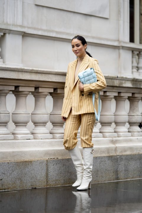 striped suit pants tucked into boots