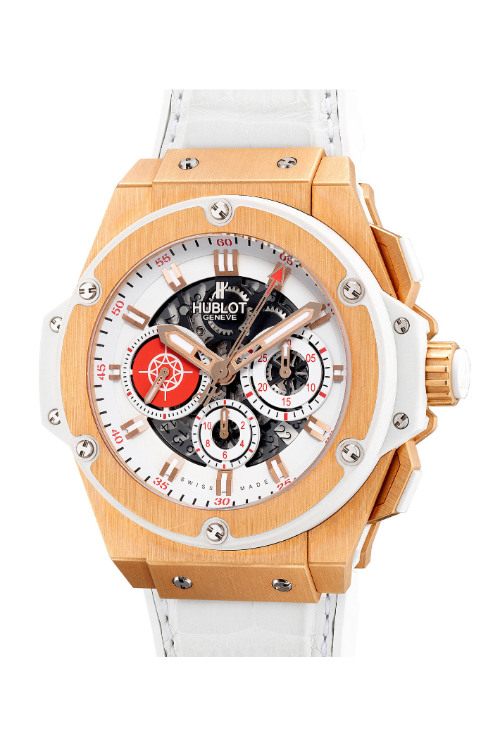 A gold watch with a gold bezel and red and white accents