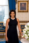 Michelle Obama, Human, Person, Clothing, Apparel, Plant, Flower, Blossom, and Flower Bouquet