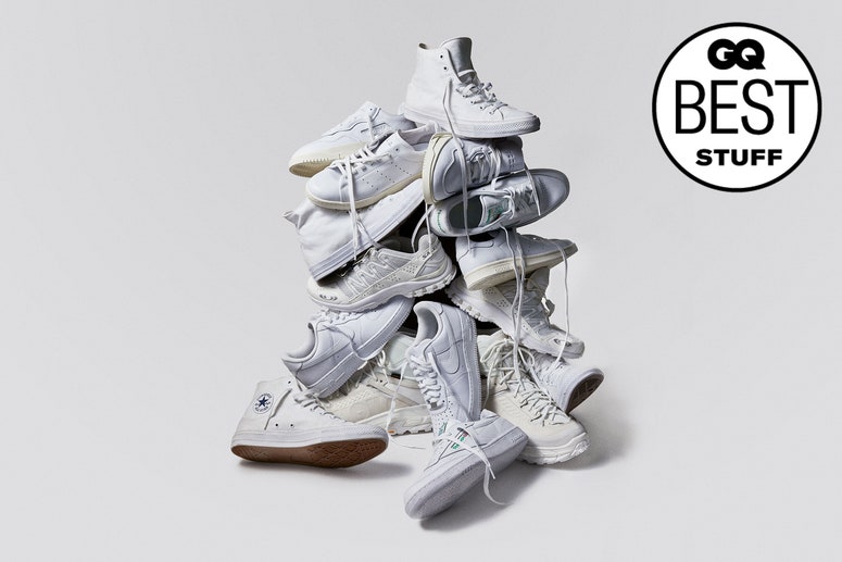 A pile of different white sneakers