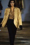 Image may contain: Yasmeen Ghauri, Clothing, Apparel, Human, Person, Coat, Overcoat, Runway, Suit, and Fashion