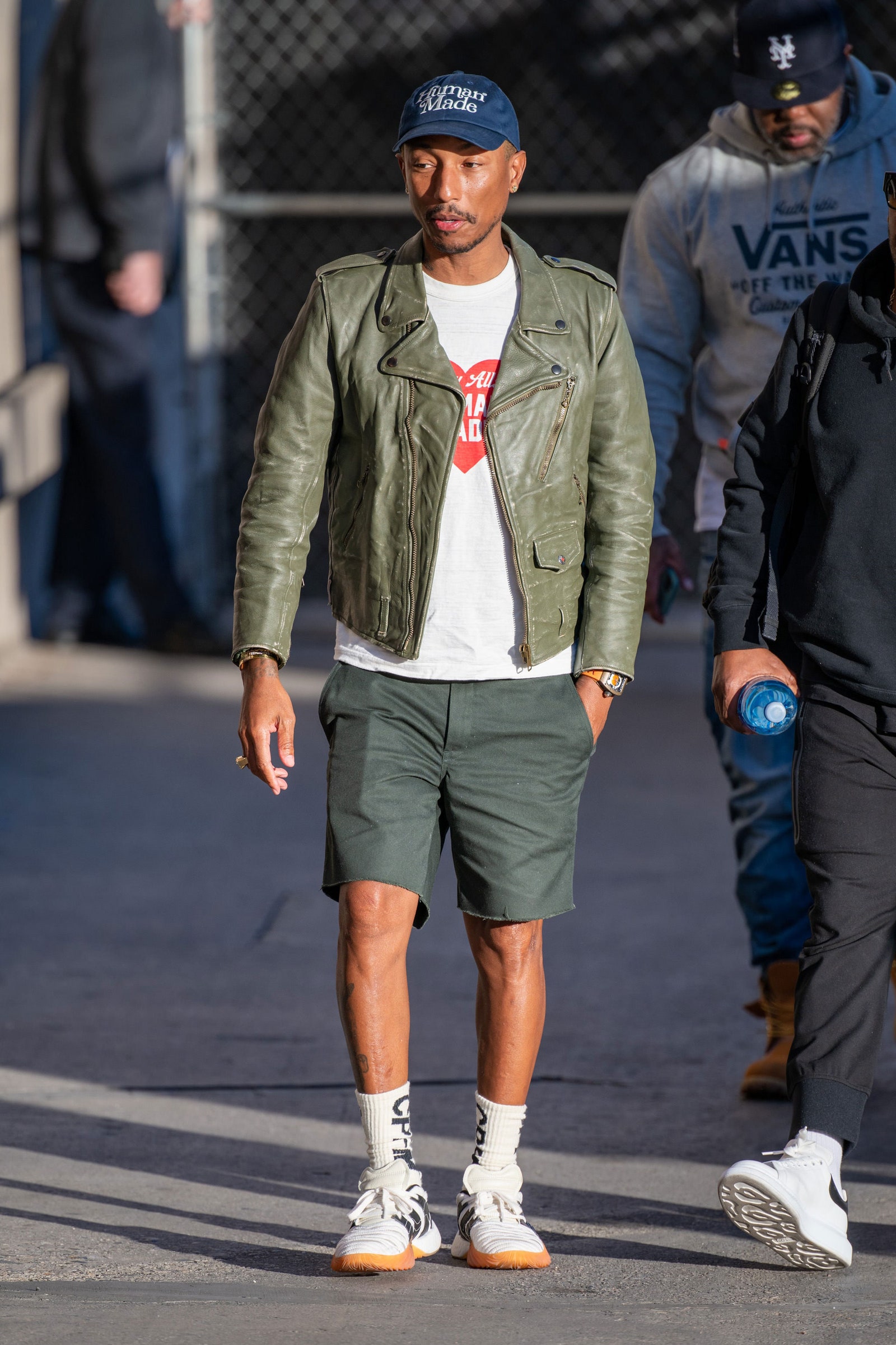 Image may contain Pharrell Williams Jacket Coat Clothing Apparel Footwear Shoe Human Person Helmet and Blazer