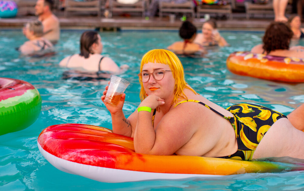 all go stock photo. plus size person in swimming pool- memorial day 