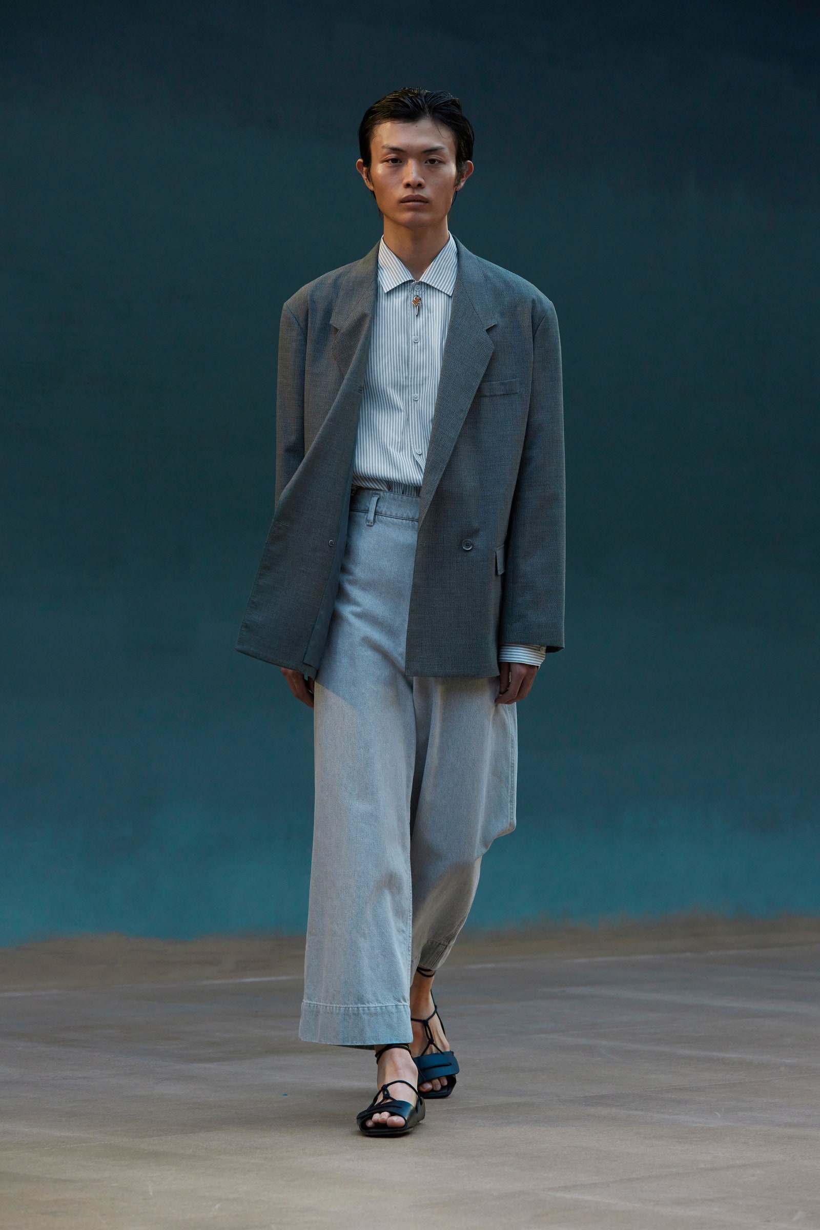 Image may contain Clothing Apparel Sleeve Overcoat Coat Human Person Suit and Runway
