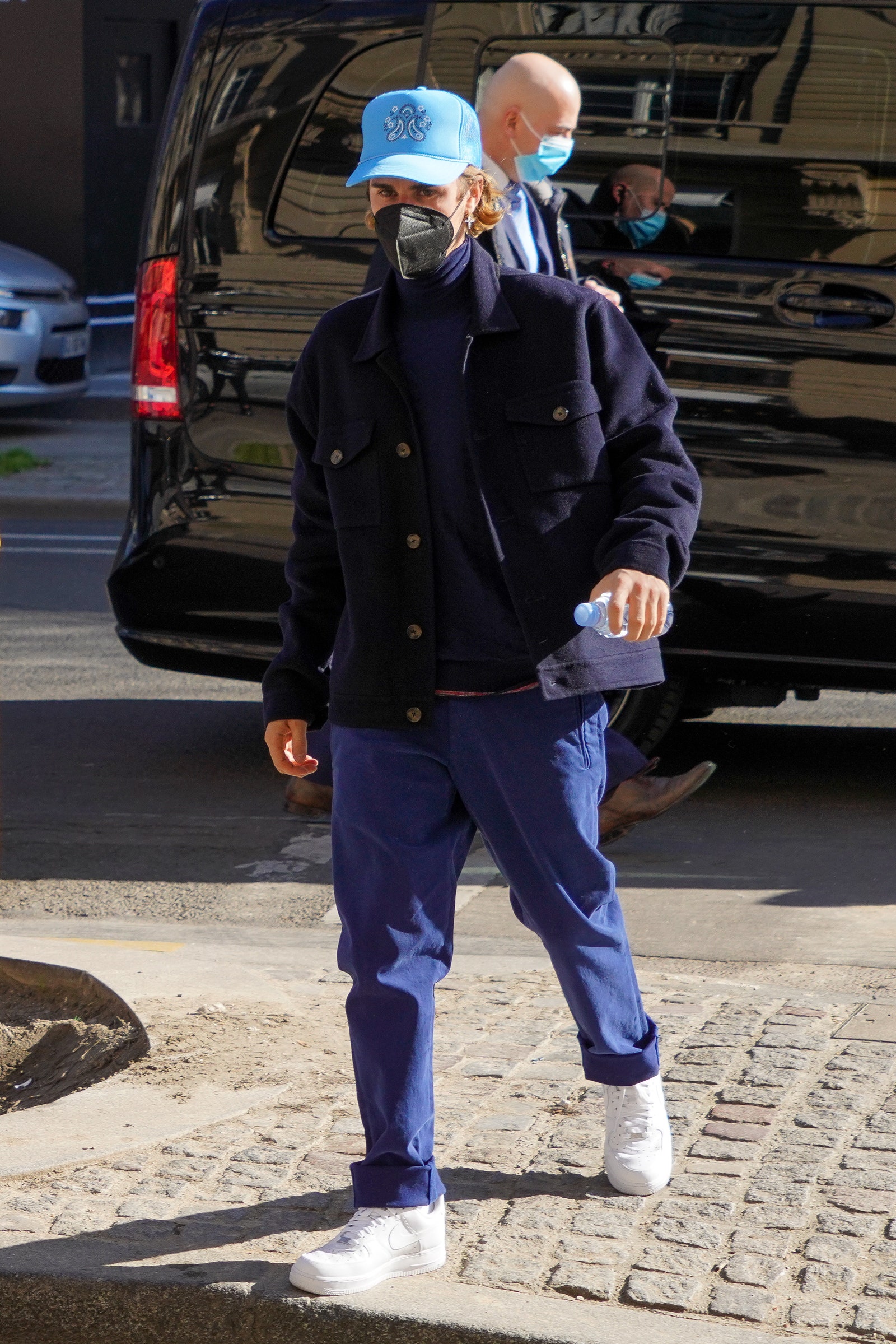 Image may contain Clothing Apparel Footwear Shoe Transportation Vehicle Automobile Car Human Person and Hat