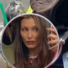 Image may contain: Bella Hadid, Human, Person, Face, Clothing, Hat, and Apparel