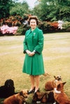 Image may contain: Clothing, Apparel, Coat, Dress, Plant, Grass, Human, Person, Elizabeth II, Animal, Pet, Canine, and Dog