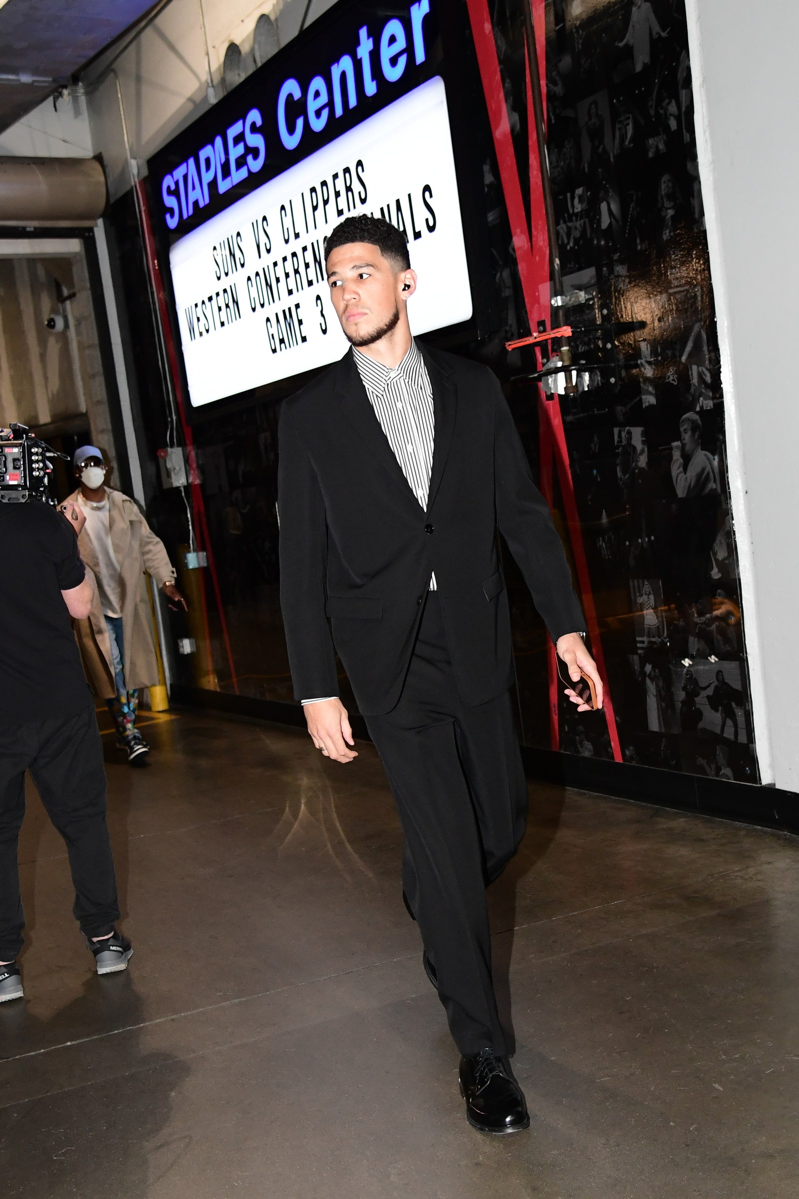 Image may contain Footwear Clothing Shoe Apparel Human Person Suit Coat Overcoat and Fashion