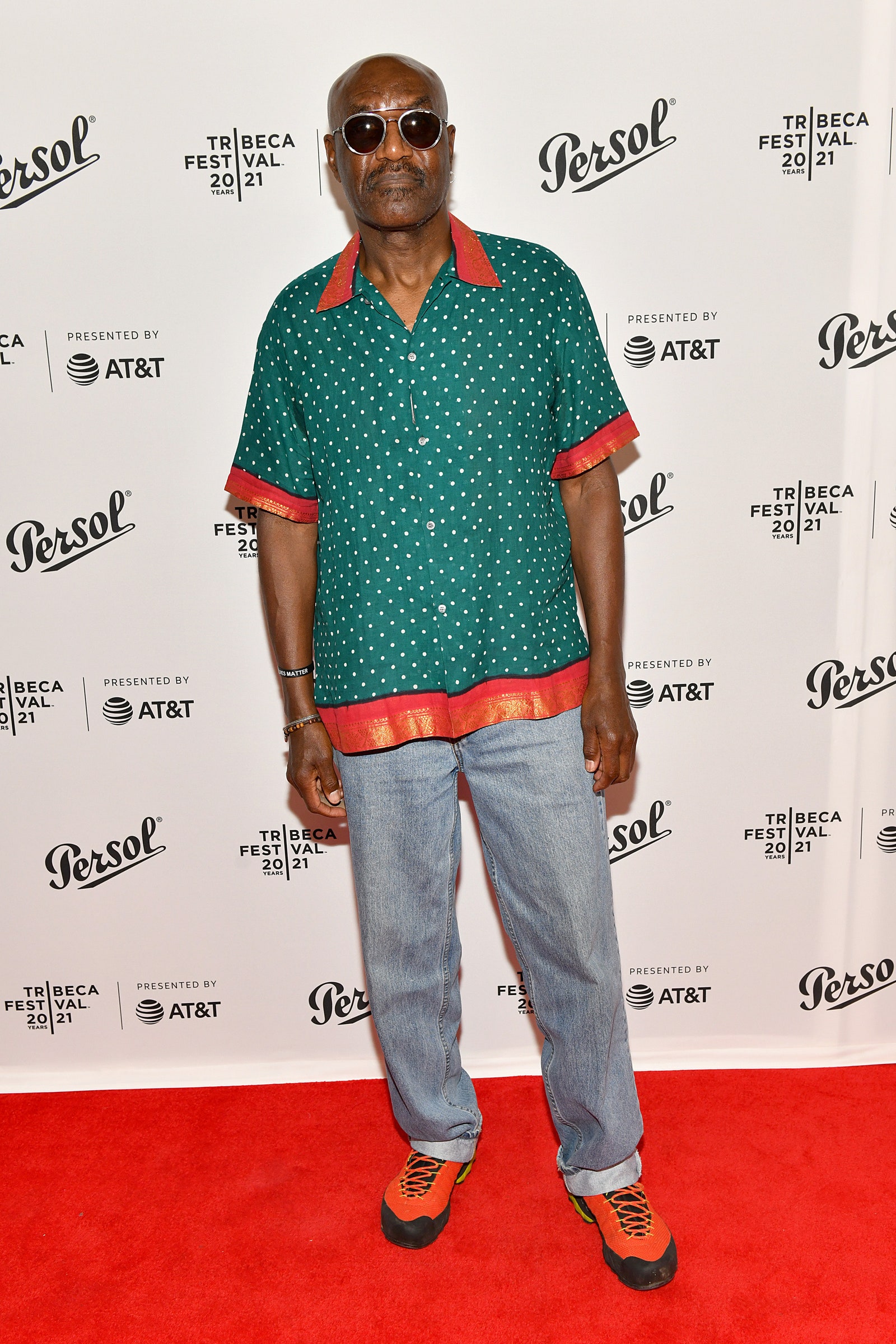 Image may contain Sunglasses Accessories Accessory Human Person Fashion Premiere Footwear Clothing and Shoe