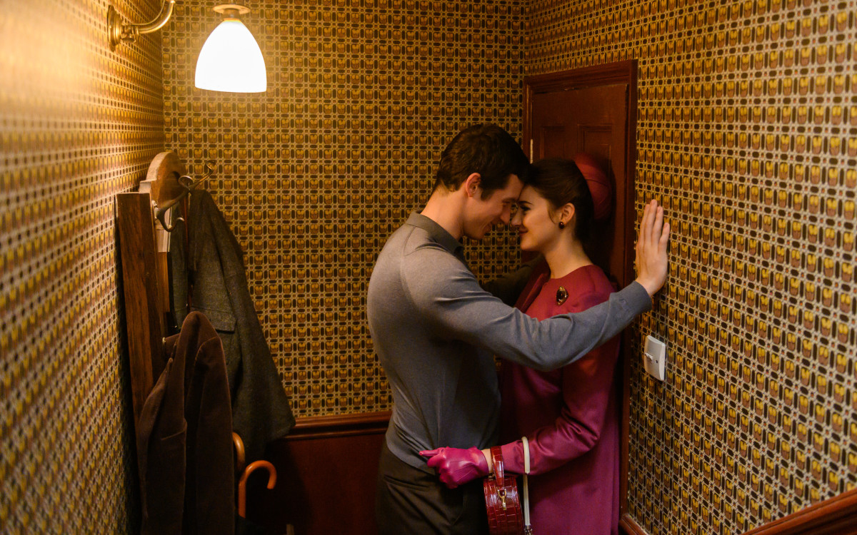 Anthony (Callum Turner) and Jennifer in one of her meticulous outfits, featuring the coat with the stunning back.