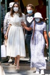 Image may contain: Clothing, Apparel, Human, Person, Footwear, Shoe, Evening Dress, Fashion, Gown, Robe, Hat, and Sleeve