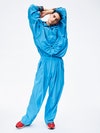 Ludwig. Hooded top and large trousers in nylon ripstop, Kenzo; shirt in yarn- dyed chequered Oxford fabric, Diesel; sneakers in calfskin and technical fabric, Lanvin.