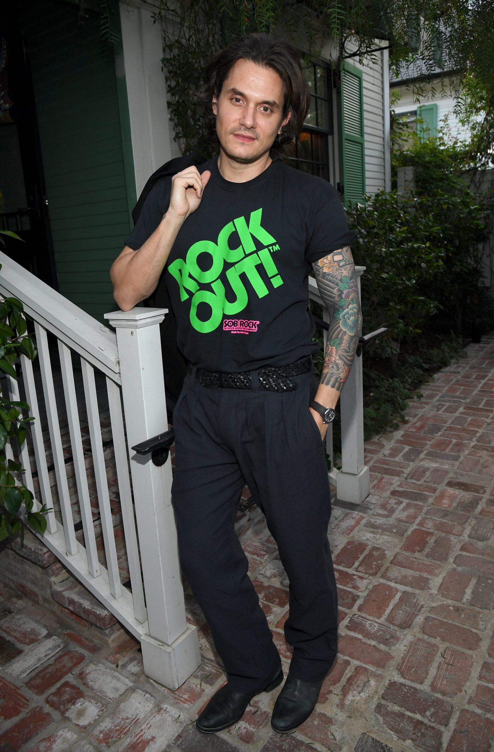 Image may contain John Mayer Skin Human Person Clothing Sleeve Apparel Footwear Shoe Railing and Banister
