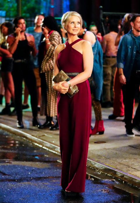 Cynthia Nixon wearing a red dress while filming
