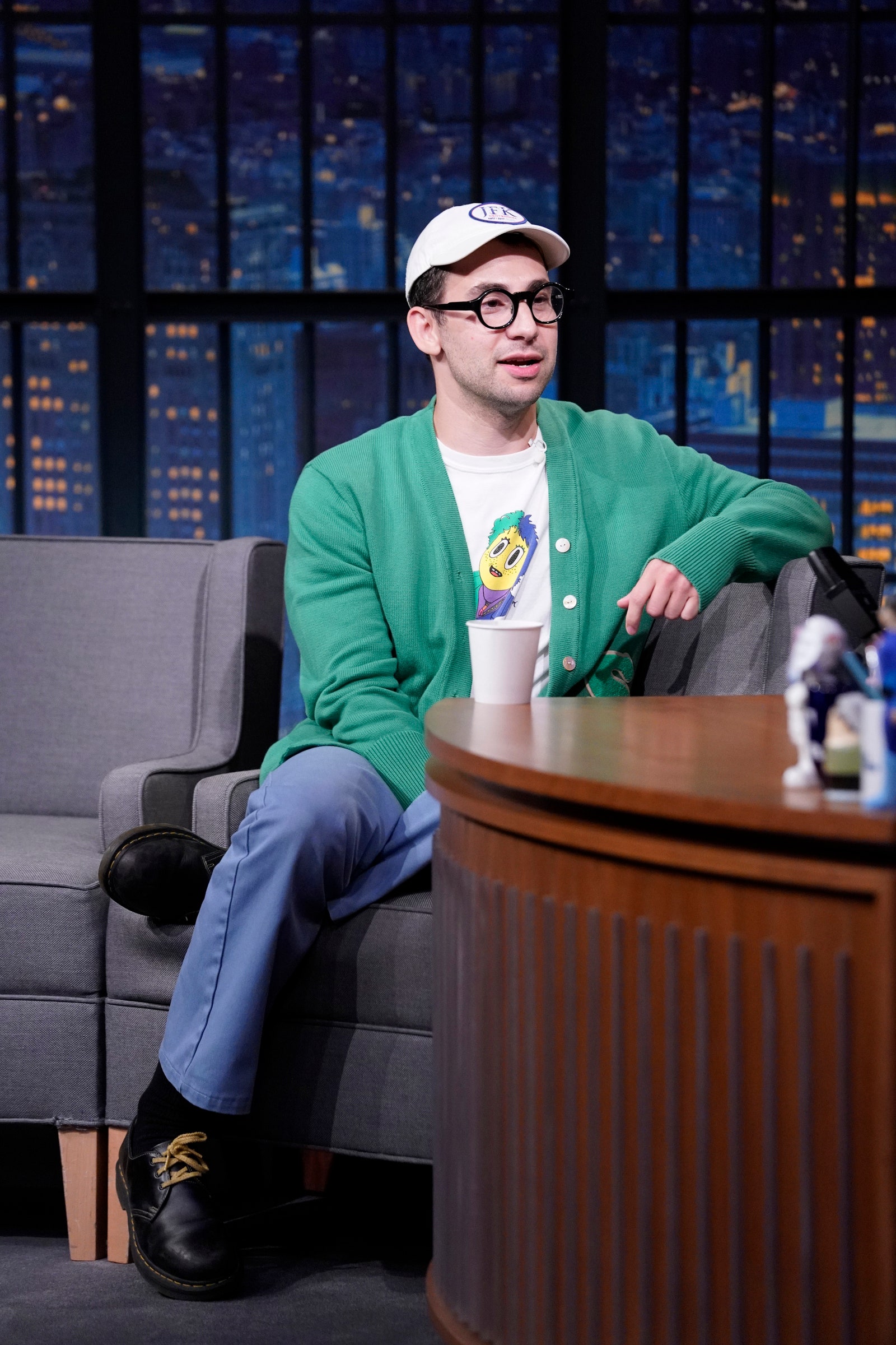 Image may contain Sitting Human Person Furniture Jack Antonoff Couch Indoors Footwear Clothing Shoe and Apparel