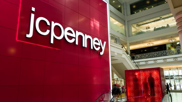 Signage is displayed at the entrance of a JC Penney department store inside the Manhattan Mall