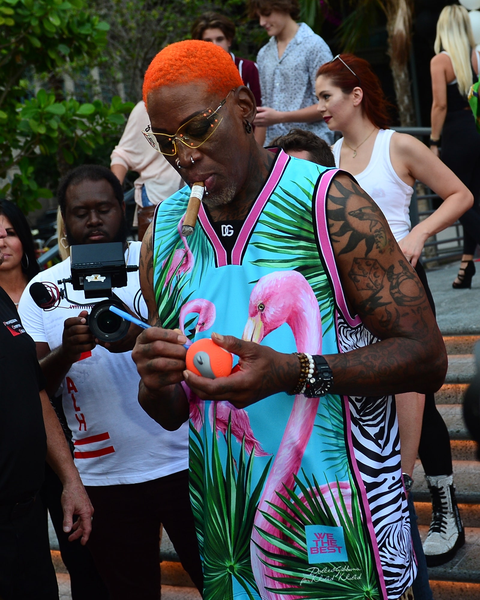 Dennis Rodman signs an autograph for fans