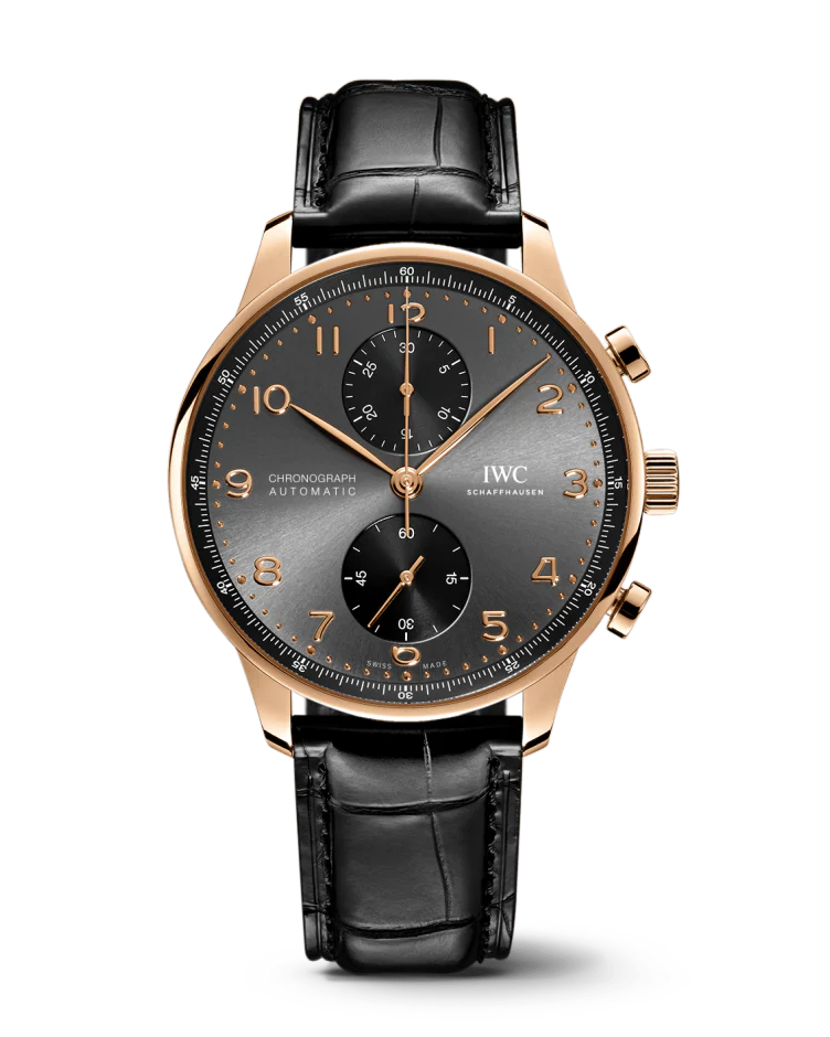 A gold watch with a black face with gold accents