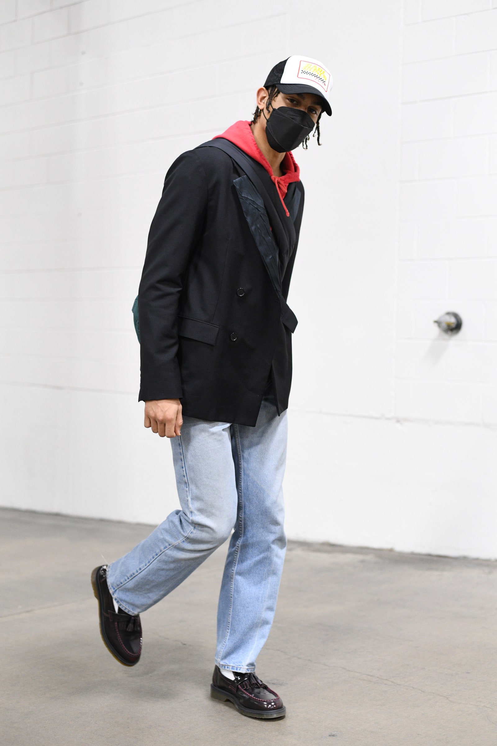 Image may contain Clothing Apparel Footwear Shoe Helmet Human Person Coat Overcoat Pants Denim and Jeans