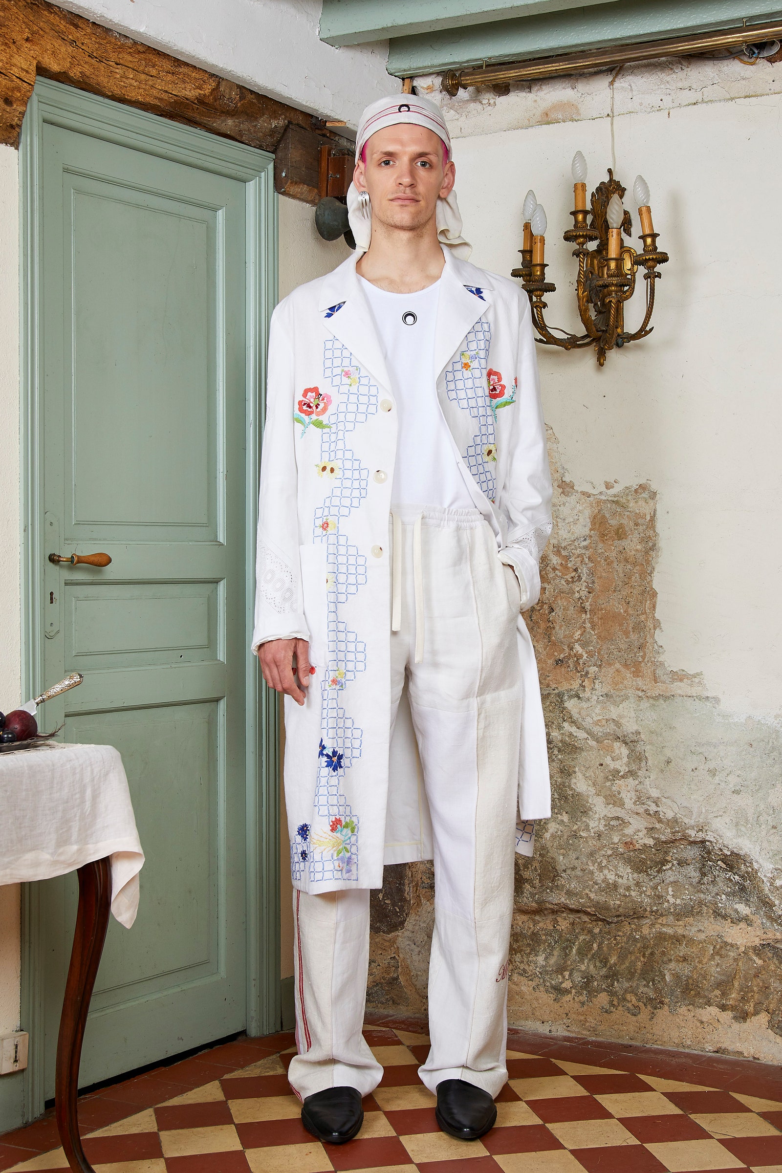 Image may contain Clothing Apparel Sleeve Home Decor Human Person Long Sleeve Door and Coat