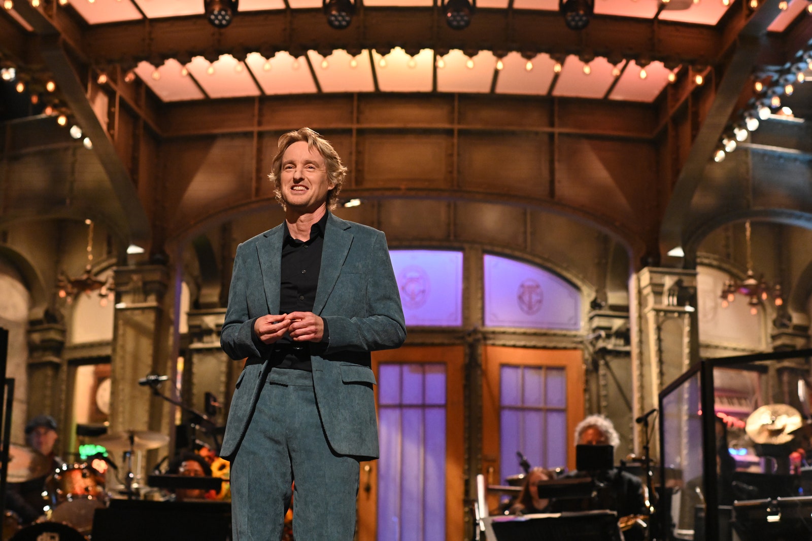 Image may contain Owen Wilson Interior Design Indoors Human Person Stage Leisure Activities Performer Suit and Coat