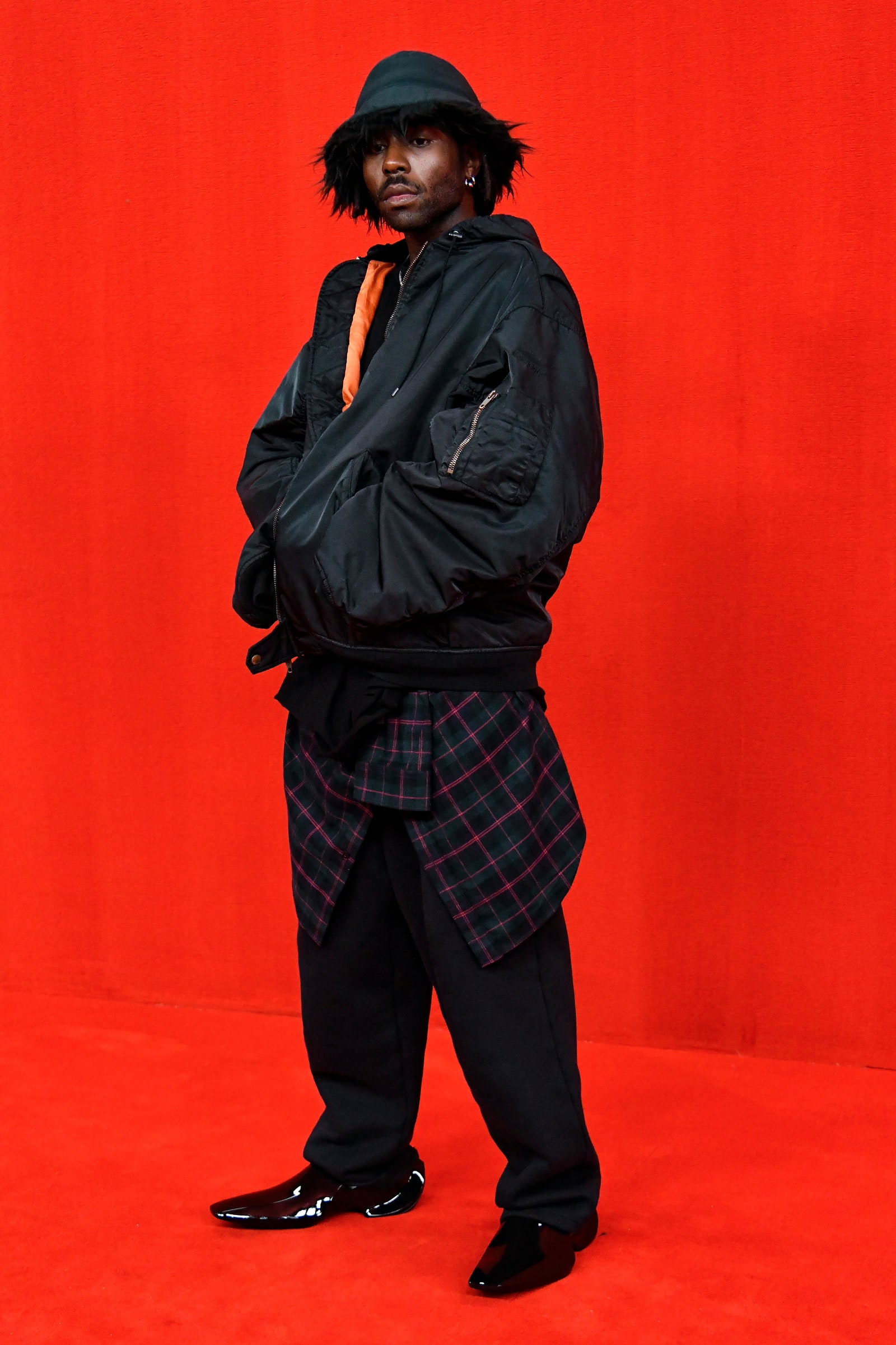 Image may contain Human Person Clothing Apparel Jacket Coat and Sleeve