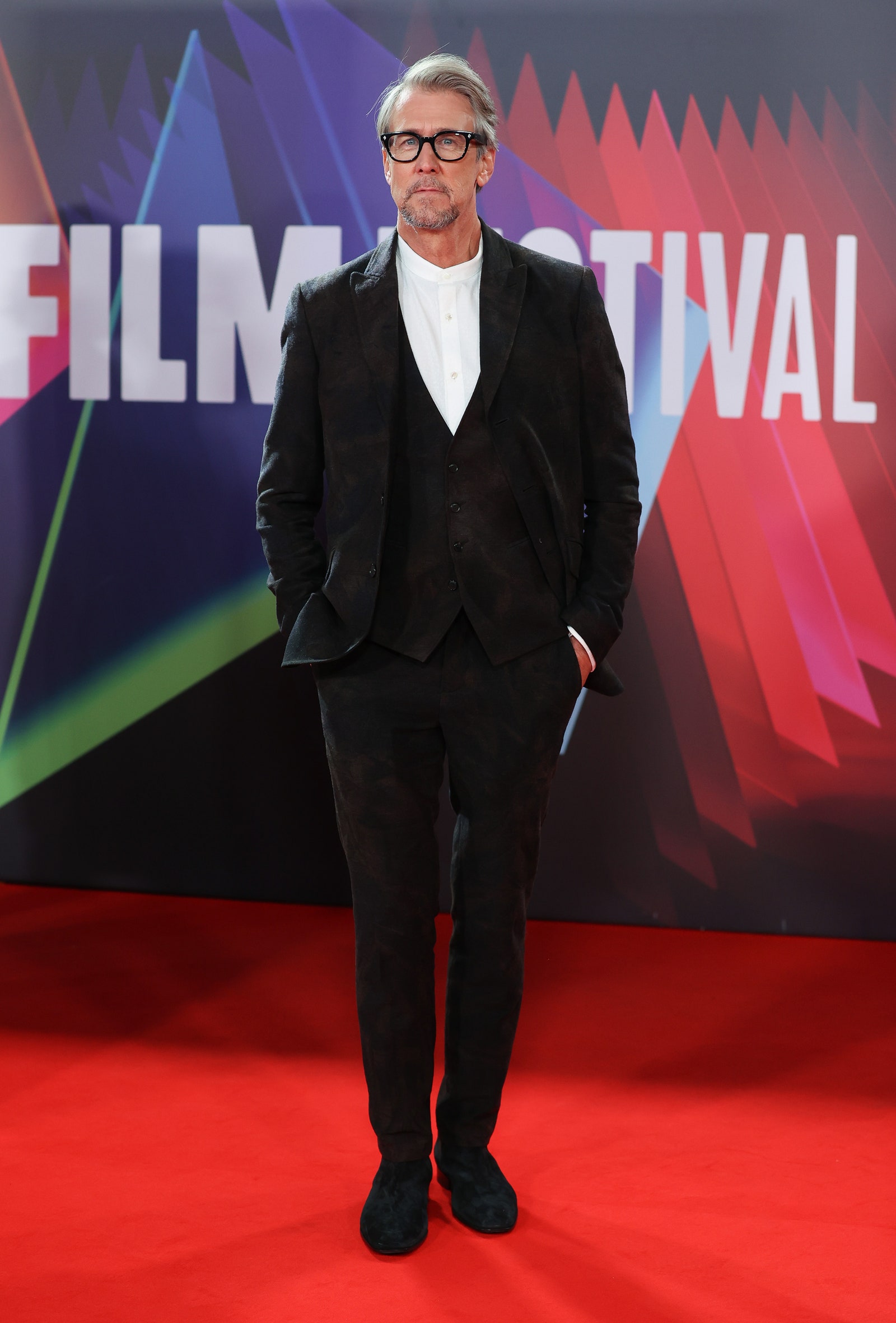 Image may contain Alan Ruck Fashion Premiere Red Carpet Red Carpet Premiere Clothing Suit Overcoat Apparel and Coat