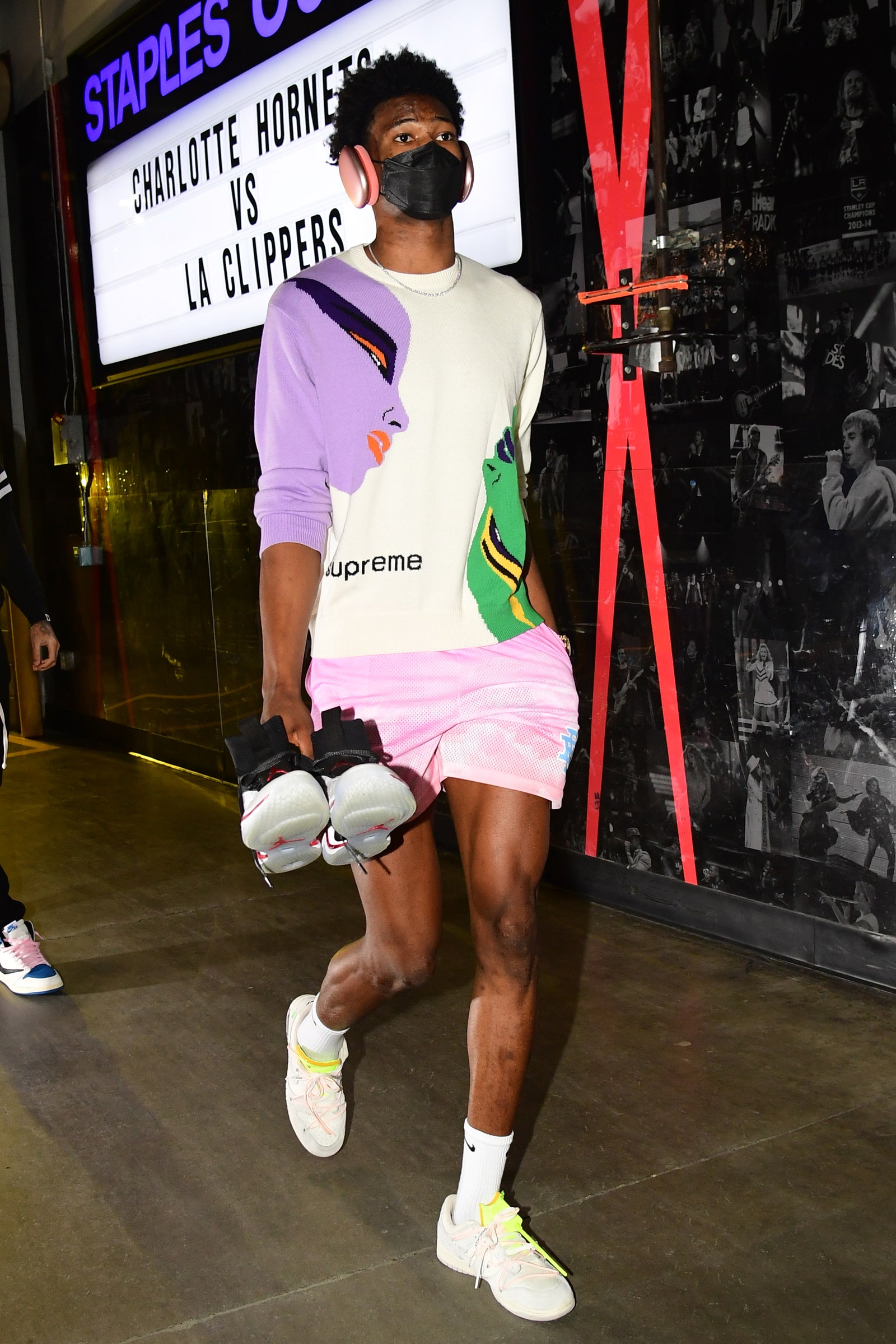 Image may contain Clothing Apparel Shorts Shoe Footwear Human Person Running Shoe and Sleeve