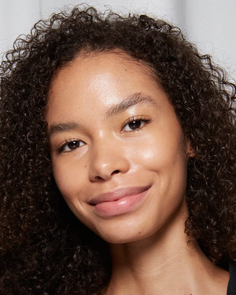 natural hair growth woman smiling with curly hair