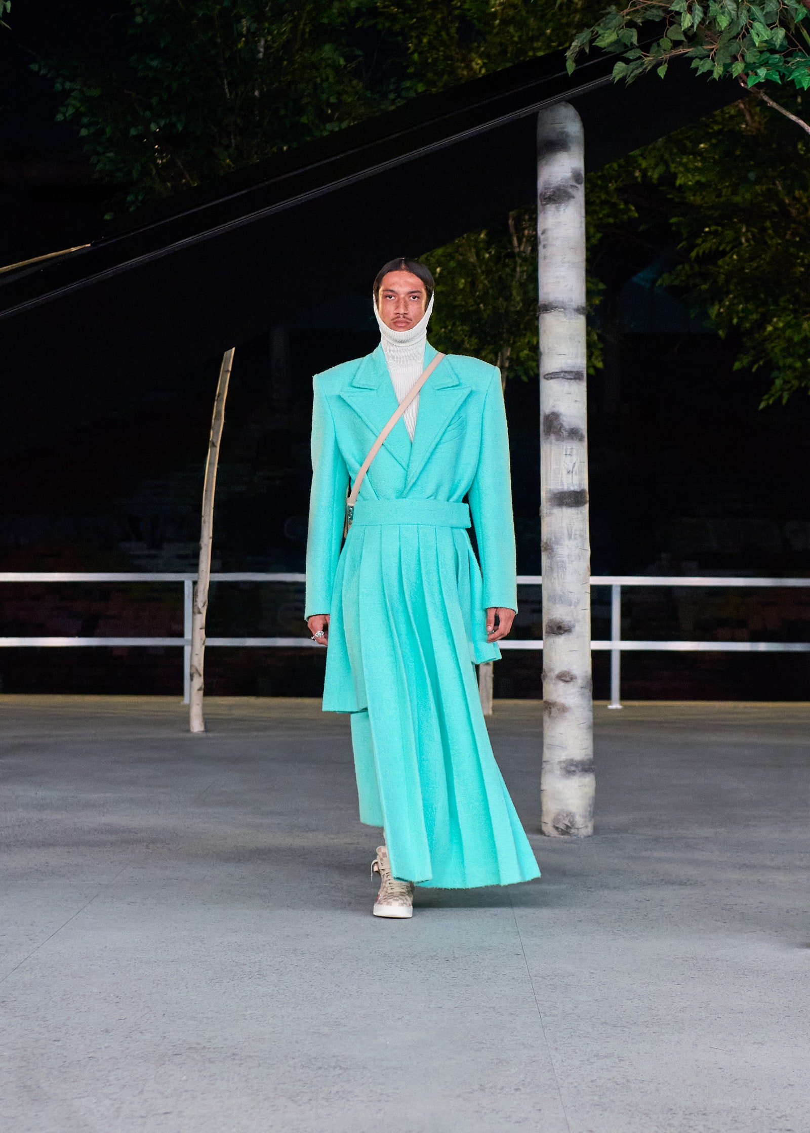 Image may contain Clothing Sleeve Apparel Dress Long Sleeve Human Person Coat Overcoat Suit and Evening Dress