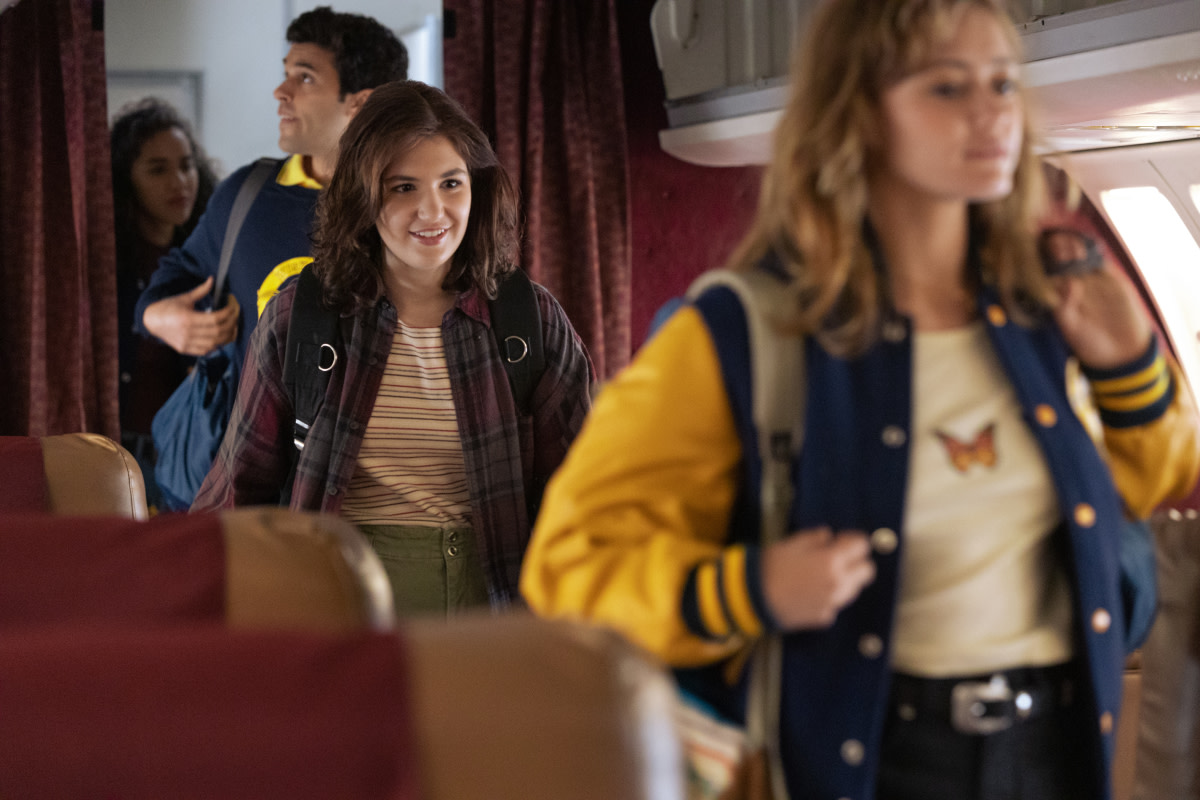 Jackie (Ella Purnell, right) in her butterfly T-shirt.