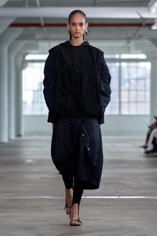 a model walks the spring 2025 Tibi runway wearing the legging layering trend